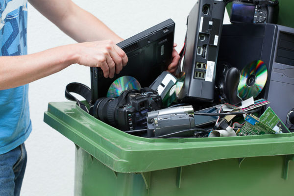 Putting used and old computer hardware into the dustbin.